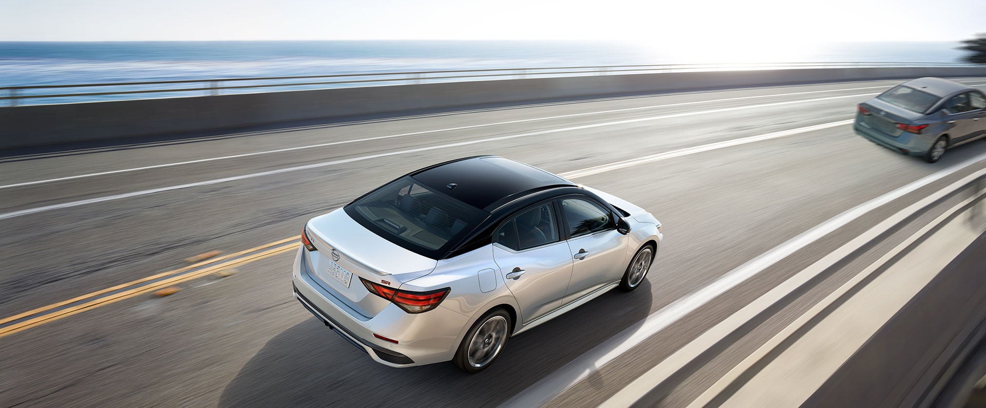 Nissan Sentra driving down a sunny highway